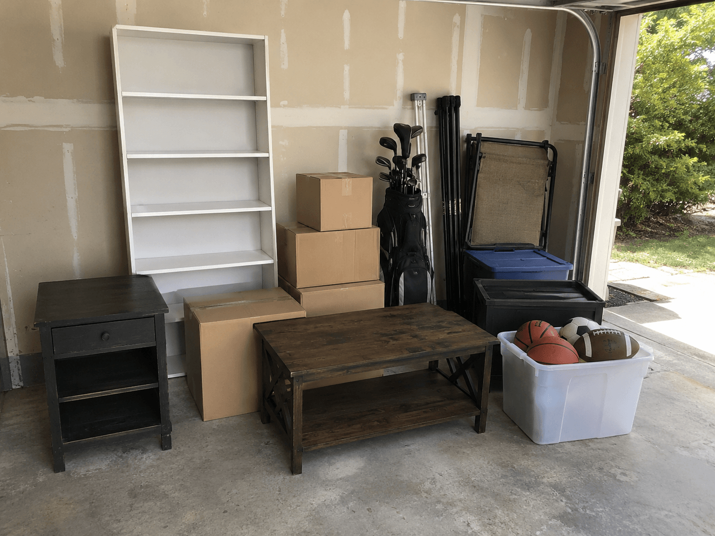 Close photo of grouped garage items for sorting and removal.